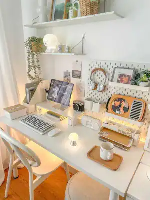 Modern workspace with computer, headphones, and creative tools for web design.